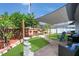 Private backyard featuring a patio, garden, shaded pergola and brick pavers at 204 Bay Meadow Dr, Kissimmee, FL 34746