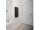 Bright bathroom with white tile and access door at 204 Bay Meadow Dr, Kissimmee, FL 34746