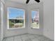 Bright bedroom featuring tile floors, two large windows, and a closet with white doors at 204 Bay Meadow Dr, Kissimmee, FL 34746