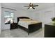 Bedroom features tile floors, a ceiling fan, and a window overlooking a covered patio at 204 Bay Meadow Dr, Kissimmee, FL 34746