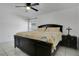 Bedroom features tile floors, a ceiling fan, and a window overlooking a covered patio at 204 Bay Meadow Dr, Kissimmee, FL 34746