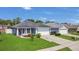 Well-kept home with lush green lawn, attached garage, and a pleasant exterior paint scheme at 204 Bay Meadow Dr, Kissimmee, FL 34746