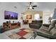 Inviting living room showcases a ceiling fan, wall-mounted TV, and an adjacent dining area at 204 Bay Meadow Dr, Kissimmee, FL 34746