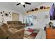 Comfortable living room features reclining sofas, a ceiling fan, and a decorative display shelf at 204 Bay Meadow Dr, Kissimmee, FL 34746