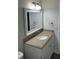 Bathroom featuring a white vanity with a granite countertop, an undermount sink, and a framed mirror at 205 Brighton Way, Casselberry, FL 32707