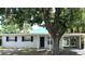 Charming single-story home featuring a carport and a lush, shady tree in the front yard at 205 Brighton Way, Casselberry, FL 32707