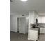 Open kitchen view with gray vinyl floors, new white cabinets and stainless appliances at 205 Brighton Way, Casselberry, FL 32707