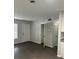 Bright living room featuring gray walls and wood-look flooring, with entry door and closet at 205 Brighton Way, Casselberry, FL 32707