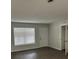 Bright living room with fresh paint, a large window, and new flooring at 205 Brighton Way, Casselberry, FL 32707