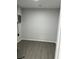 Empty room with light gray walls, a circuit breaker box, and gray-brown vinyl flooring at 205 Brighton Way, Casselberry, FL 32707