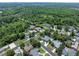 An aerial view of the neighborhood, surrounded by lush greenery, with views of the nearby lake at 2106 Tuscarora Trl, Maitland, FL 32751