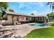 Beautiful backyard showcasing a pool, paved patio, well-maintained lawn, and lovely landscaping at 2106 Tuscarora Trl, Maitland, FL 32751