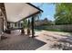 Backyard featuring a covered patio with wooden chairs, an outdoor umbrella, and a serene pool at 2106 Tuscarora Trl, Maitland, FL 32751