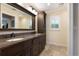 Bathroom featuring a dual sink vanity with dark wood cabinets and granite countertop at 2106 Tuscarora Trl, Maitland, FL 32751