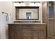 Bathroom featuring a dual sink vanity with dark wood cabinets and granite countertop at 2106 Tuscarora Trl, Maitland, FL 32751