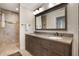 Bathroom featuring a dual sink vanity with dark wood cabinets and granite countertop at 2106 Tuscarora Trl, Maitland, FL 32751