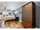 Comfortable bedroom with hardwood floors, a ceiling fan, and a storage cabinet at 2106 Tuscarora Trl, Maitland, FL 32751