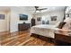Bright bedroom featuring hardwood floors, a ceiling fan, and large windows at 2106 Tuscarora Trl, Maitland, FL 32751