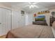 Cozy bedroom features a ceiling fan and ample closet space at 2106 Tuscarora Trl, Maitland, FL 32751