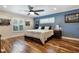 Large bedroom with hardwood floors, a ceiling fan, and plenty of natural light at 2106 Tuscarora Trl, Maitland, FL 32751