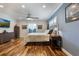 Spacious bedroom with hardwood floors, natural light, and a mounted TV at 2106 Tuscarora Trl, Maitland, FL 32751