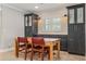 Cozy dining area features a wooden table, red leather chairs, and built in cabinets and drawers with modern lighting fixtures at 2106 Tuscarora Trl, Maitland, FL 32751