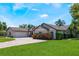 Beautiful home exterior showcasing lush landscaping, a circular driveway, and a well-manicured lawn at 2106 Tuscarora Trl, Maitland, FL 32751