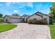 Charming home exterior showcasing brick driveway and well-maintained landscaping at 2106 Tuscarora Trl, Maitland, FL 32751