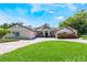 Stunning exterior with manicured lawn, brick driveway, and beautiful landscaping at 2106 Tuscarora Trl, Maitland, FL 32751
