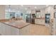 Bright, open kitchen with stainless steel appliances, stone countertops and floors, and modern white cabinetry at 2106 Tuscarora Trl, Maitland, FL 32751