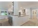 Bright kitchen features an island, stainless steel appliances, a wine fridge, and modern white cabinets at 2106 Tuscarora Trl, Maitland, FL 32751