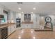 Bright kitchen boasts stainless steel appliances, granite counters, stone backsplash, and modern white cabinetry at 2106 Tuscarora Trl, Maitland, FL 32751