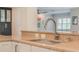 Modern kitchen sink and countertop with a view of the living room area at 2106 Tuscarora Trl, Maitland, FL 32751