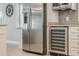 Modern kitchen with a stainless steel refrigerator, wine cooler and modern cabinets at 2106 Tuscarora Trl, Maitland, FL 32751