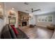 Cozy living room with brick fireplace, hardwood floors, and a comfortable sofa at 2106 Tuscarora Trl, Maitland, FL 32751