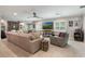 Spacious living room with plush seating, brick fireplace, ceiling fans, and natural light from plantation shutter windows at 2106 Tuscarora Trl, Maitland, FL 32751