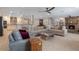 Spacious living room featuring a large sofa, fireplace, and open kitchen with modern countertops and stainless steel appliances at 2106 Tuscarora Trl, Maitland, FL 32751
