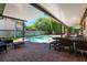 Covered patio with brick pavers overlooking a private pool and backyard oasis at 2106 Tuscarora Trl, Maitland, FL 32751