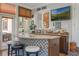 Sunroom wet bar features granite countertop and mosaic backsplash at 2106 Tuscarora Trl, Maitland, FL 32751