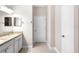 Neutral bathroom featuring white cabinets with granite counters, tile floors, and a linen closet at 2125 Shackley Pl, Apopka, FL 32703