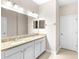 Bright bathroom with double sinks, granite countertops, tile flooring, and neutral wall colors at 2125 Shackley Pl, Apopka, FL 32703