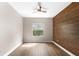 Modern bedroom featuring wood-look flooring, ceiling fan, and a decorative wood accent wall at 2125 Shackley Pl, Apopka, FL 32703