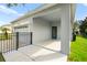 Covered entrance showcasing a blue front door, neutral exterior paint, and black metal fencing at 2125 Shackley Pl, Apopka, FL 32703