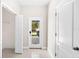 Bright entryway with tile flooring, white walls, closet, and view of outdoor patio at 2125 Shackley Pl, Apopka, FL 32703