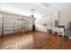 Spacious garage with wooden floors, sink, laundry, storage shelving and abundant natural light at 2125 Shackley Pl, Apopka, FL 32703