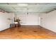 Spacious garage with wooden floors and convenient storage shelving at 2125 Shackley Pl, Apopka, FL 32703