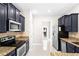 Modern kitchen featuring dark cabinets, granite countertops, and stainless steel appliances at 2125 Shackley Pl, Apopka, FL 32703