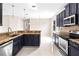 Open kitchen with dark cabinets, granite countertops, stainless steel appliances, and eat-in breakfast bar at 2125 Shackley Pl, Apopka, FL 32703