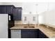 Open kitchen with breakfast bar, dark cabinets, stainless steel dishwasher, and granite countertops at 2125 Shackley Pl, Apopka, FL 32703