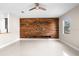 Living room with wood accent wall and tile floor at 2125 Shackley Pl, Apopka, FL 32703